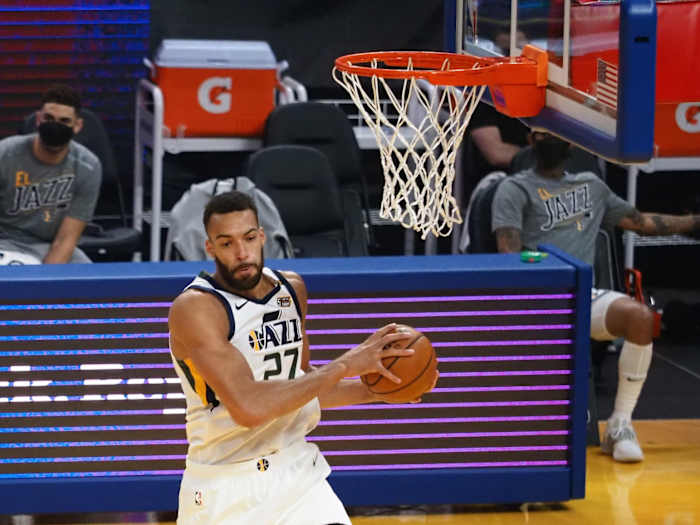 Rudy Gobert (27) snags a rebound against the Golden State Warriors on Sunday afternoon.